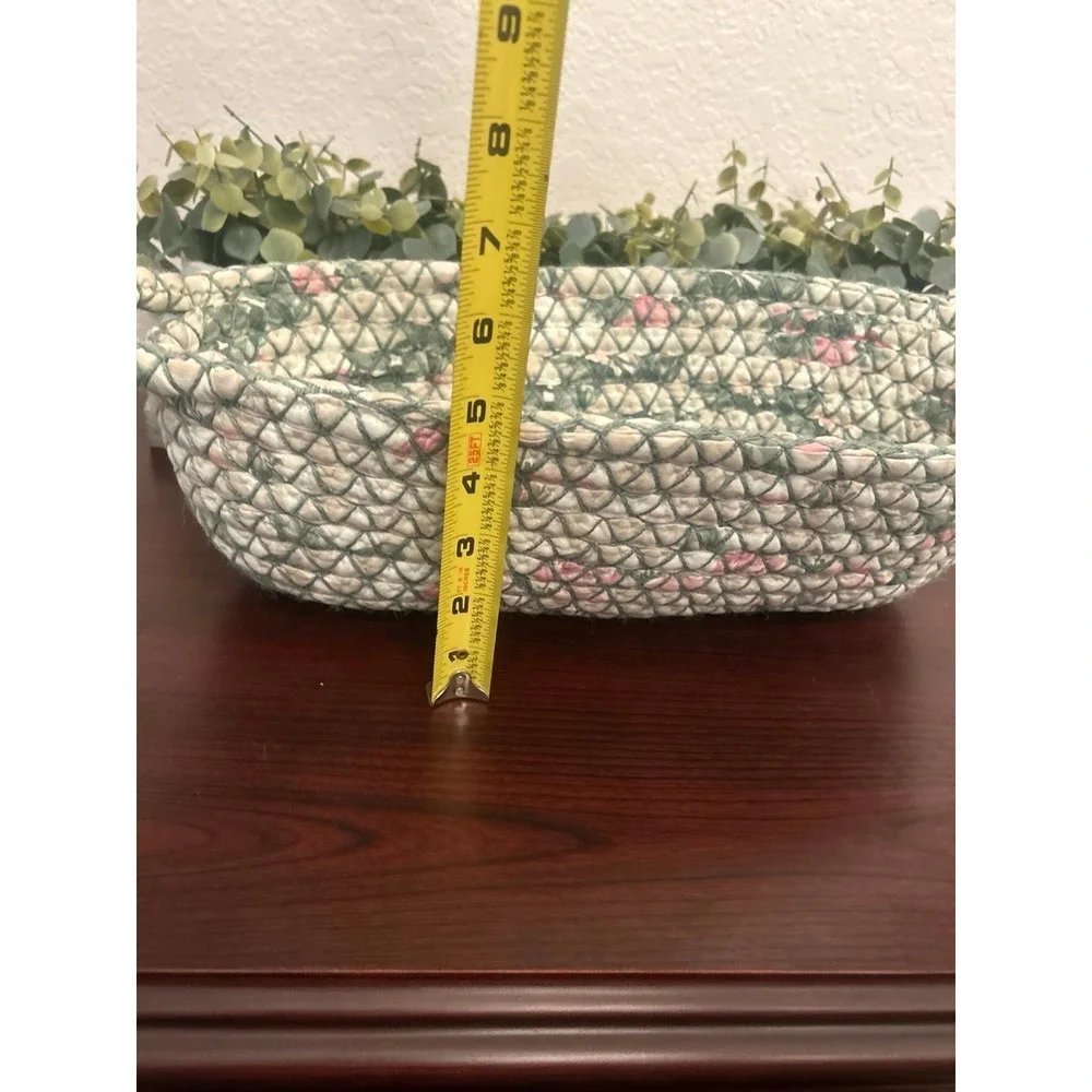 vintage oval rag rug basket features a braided, quilted design in green and pink